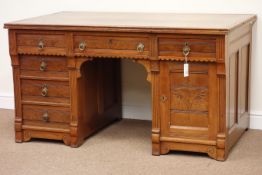 Late 19th century aesthetic movement knee hole desk, fitted with six drawers and single cupboard,