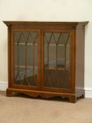 Reproduction mahogany glazed bookcase enclosed by two doors, carved detail, fluted half columns,