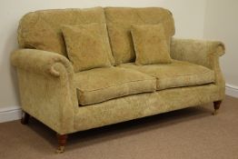 Large two seat sofa upholstered in golden chenille patterned fabric raised on mahogany finish feet,
