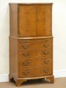 Reproduction walnut cocktail cabinet enclosed by two doors above slide,