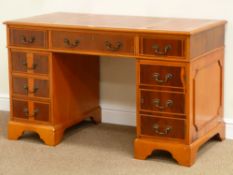 Reproduction figured yew wood twin pedestal desk fitted with six drawers and cupboard,