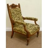 Quality Edwardian golden oak armchair, heavily carved with foliage and shield top pediment,