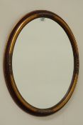 Oval gilt and red finish mirror,