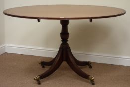 G T Rackstraw Regency style mahogany oval dining table on turned pedestal with quadruple splay legs,