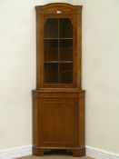 Reproduction walnut corner cupboard fitted with display cabinet above enclosed by single glazed