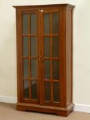 Mahogany bookcase enclosed by two glazed doors, fitted with three shelves, W97cm, H179cm,