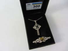 Celtic cross pendant necklace set with Whitby jet and a green amber brooch both stamped 925