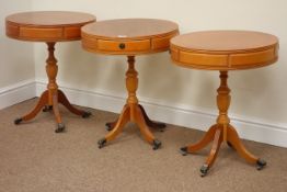 Three reproduction yew wood drum tables fitted with two drawers, D50cm,