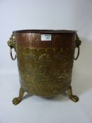 Early 20th century embossed brass and copper log bin with lion mask ring handles H39cm