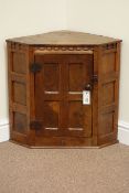 Yorkshire Oak - 'Gnomeman' adzed oak corner cupboard enclosed by single burr oak panelled door,