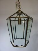 Set of three hexagonal burnished metal lanterns with bevelled glass panes,