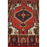Persian Hamadan woollen red ground rug,