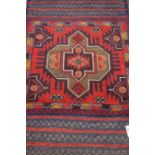 Tribal Balochi red and blue ground rug,