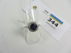 Purple sapphire and diamond halo set ring with diamond shoulders hallmarked 18ct (sapphire approx 1.
