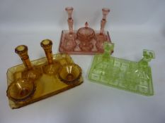 Three Art Deco period coloured glass dressing table sets