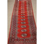 Pakistani Bokhara red ground runner rug, gules pattern,