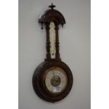 Early 20th century aneroid barometer mounted on carved walnut,