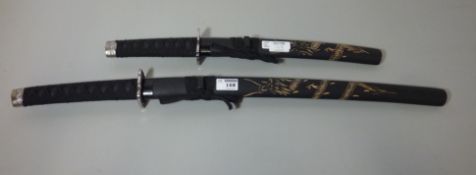 Two modern Japanese 'Ancient Warrior' swords and scabbards with carved decoration