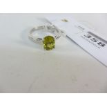 White gold ring set with a yellow stone hallmarked 9ct