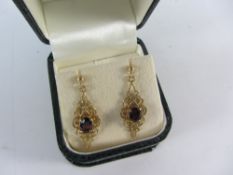 Pair of garnet set gold pendant ear-rings