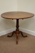 Early 19th century circular flamed mahogany tilt top table on turned pedestal base fitted with