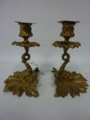 Pair early 20th century gilded brass candlesticks modelled as classical dolphins,