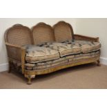 Early 20th century walnut framed bergere lounge suite, scroll arms with carved detail,