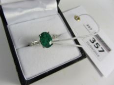 Oval emerald and channel set diamond white gold ring hallmarked 18ct