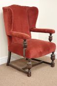 Early 20th century oak framed wingback armchair upholstered in red cover Condition Report