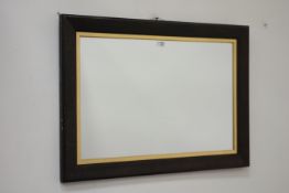 Rectangular wall mirror on dark oak frame with gilt mount,