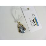 Gold pendant set with a diamond and pale blue stone