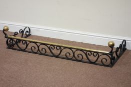 Wrought iron fender with brass rail,