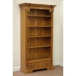 Solid pine bookcase fitted with four adjustable shelves, single drawer to base, dentil cornice,