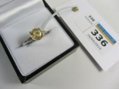 White 18ct gold ring set with a yellow sapphire and tapered diamonds hallmarked (sapphire approx 2