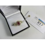 Oval ruby and diamond cluster ring hallmarked 18ct