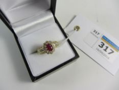 Oval ruby and diamond cluster ring hallmarked 18ct