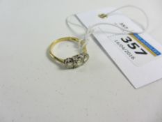 Three stone diamond ring stamped 18ct (centre stone 0.