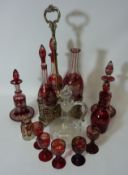 Late Victorian silver-plated three bottle holder containing three similar ruby overlaid glass