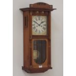 Edwardian walnut wall hanging clock, mounted brass decoration, turned columns and carved detail,