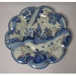 Late 18th/early 19th century tin glazed dish with scalloped border and Chinese style decoration