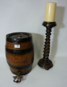 Late 19th/early 20th century metal bound oak barrel with tap and a turned wood candle stick