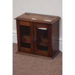 Early 20th century oak smokers cabinet, fitted interior, enclosed by two bevelled glass doors,