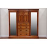Edwardian walnut triple wardrobe, centre cupboard enclosed by two panelled doors,