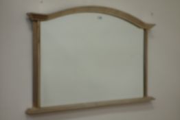Arch top overmantle mirror fitted with bevelled glass in silvered frame,