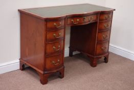 Reproduction yew wood serpentine kneehole desk fitted with nine drawers,