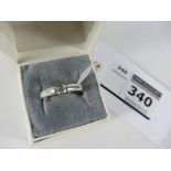 Modern 18ct white gold ring set with a baguette diamond hallmarked