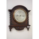 Early 20th century aneroid barometer mounted on oak with barley twist decoration,