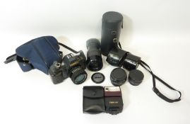 Canon T70 SLR camera with zoom lens, two additional lenses,