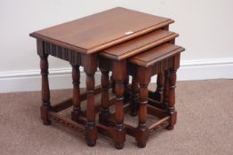 Nest of three medium oak occasional tables on turned bases,