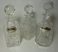 Three cut crystal decanters,